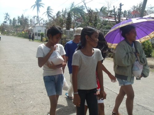 Women received relief goods in San Remegio after typhoon Yolanda 